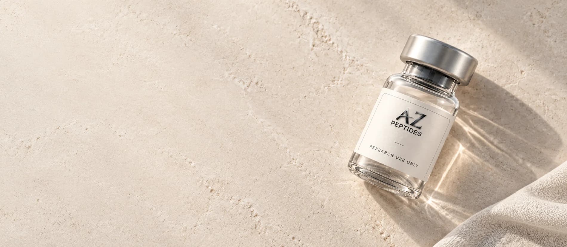 A-Z Peptides illustrative glass vial resting in natural light on pale limestone